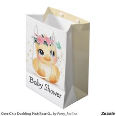 a baby shower gift bag with an image of a giraffe wearing a flower crown