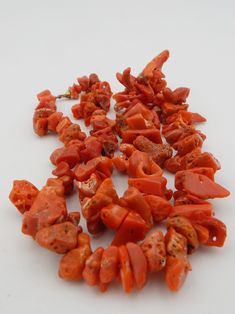 Organic in nature, and gorgeous in jewelry. A warm orange, red hue flows through the coral. Nature created the unique shapes, and the necklace celebrates the beauty. Various sizes and shapes of red coral are strung upon, what appears, to be red cotton string. There are pieces of branch coral, chunks of coral and smaller pieces. There are the natural holes and crevices in the pieces that make it even more interesting. Condition is very good. The coral appears to be in nice condition. The cotton s Unique Orange Red Coral Necklace, Orange Red Coral Jewelry With Natural Stones, Spiritual Orange Necklace Made Of Red Coral, Orange Jewelry With Natural Stones And Red Coral, Spiritual Orange Red Coral Necklace, Unique Coral Necklace With Gemstone Beads, Coral Necklace With Natural Red Coral Stones, Delicate Wedding Necklace, Delicate Silver Necklace