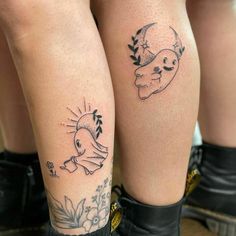 two people with tattoos on their legs