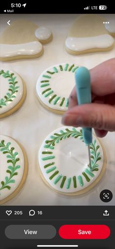 someone is decorating cookies with green icing