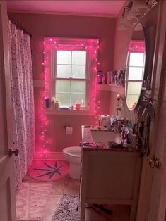 a bathroom with pink lights on the wall