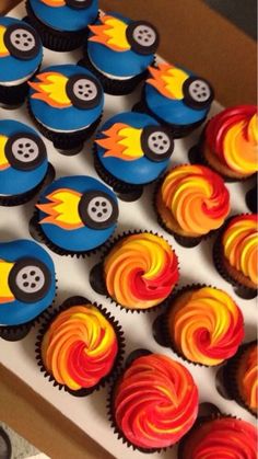 cupcakes decorated with colorful frosting in a box