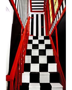 black and white checkered stairs with red handrails