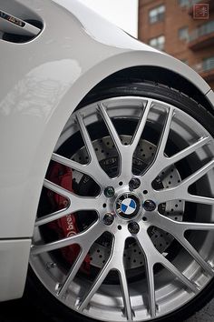 the front wheel of a white bmw car