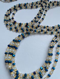 Single Strand Waist Bead - Woroba is a timeless piece inspired by the rich traditions of Ivory Coast. Meticulously handcrafted from 100% glass beads, this waist bead exudes authenticity and artistry. The deep blue color of the beads reflects the serene beauty of the Ivory Coast, adding an element of tranquility and depth to your ensemble. Each bead is a testament to the skilled craftsmanship of the artisans, showcasing the cultural richness of the region. Accentuating this single strand are silv Blue Waist Beads With Spacer Beads As Gift, Blue Beaded Waist Beads As Gift, Blue Colorful Waist Beads As Gift, Elegant Beaded Waist Beads As Gift, Elegant Waist Beads As A Gift, Elegant Handmade Waist Beads As Gift, Elegant Beaded Waist Beads For Gift, Handmade Adjustable Sapphire Beaded Necklaces, Blue Spacer Beads For Festivals