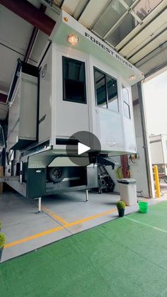 an rv parked in a garage with the door open