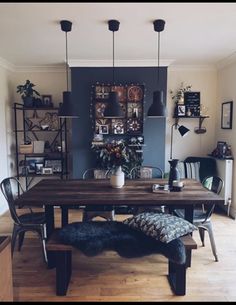 a dining room table with chairs and a bench