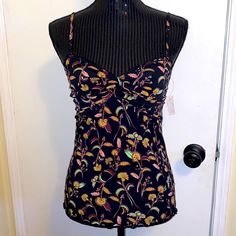 Nwt No Flaws Free People Black Floral Camisole/Tanktop Size Medium Black Sleeveless Tank Top With A Floral Print. Adjustable And Removable Spaghetti Straps. Ruched Cups With Twist Front Detail. Lettuce Hem. Smocked Back. Fitted Style. 95% Polyester, 5% Spandex Approximate Measurements Bust 14" Armpit To Armpit Shoulder To Hem: 21.5" Summer Camisole Tankini With Built-in Bra, Fitted Casual Tankini, Casual Fitted Sleeveless Tankini, Spring Sleeveless Stretch Tankini, Sleeveless Stretch Tankini For Spring, Summer Stretch Vest Camisole, Fitted Summer Tank Camisole, Stretch Sleeveless Blouse Camisole For Beach, Fitted Floral Print Tank Top For Vacation