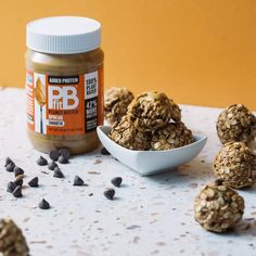 peanut butter and oatmeal granola bites next to a jar of peanut butter