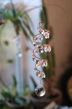 a wind chime hanging from a wire with crystal beads