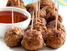 meatballs with toothpicks and dipping sauce on a plate