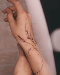 a woman's arm with a tattoo on her left hand and an arrow in the middle