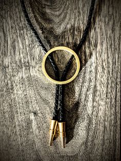 "Brass bolo, round in shape. Custom, one of a kind Bolo tips hand milled in Washington!  PLEASE HELP OUT ARTISTS AND CREATORS Etsy just jacked up all their fees through the roof and I literally can't make this item for any less than it already is. Submit feedback to Etsy about fees and I will gladly drop all of my prices! Each handmade bolo has a unique metal patina giving you a one of a kind piece. The finish is not painted, but actually a chemical reaction/oxidation so the finish becomes part of the base metal. Once the desired look is achieved, I neutralize and seal the patina so it does not continue to change and oxidize...though on the right metal this can be great!  You can dress this up or wear casual with a t-shirt. Either way people will definitely notice this unique piece. PLEASE Modern Bolo Tie, Western Style Gold Lariat Jewelry, Western Style Engraved Gold Jewelry, Western Gold Engraved Jewelry, Handmade Western Style Gold Jewelry, Engraved Gold Western Jewelry, Handmade Western Gold Jewelry, Hand Tooled Artisan Gold Jewelry, Adjustable Western Gold Jewelry