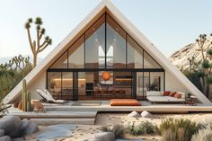 a house in the desert surrounded by rocks and cacti, with an outdoor seating area