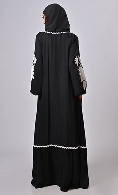 Introducing new abaya it is a loose-fitting, full-length outer garment worn by Muslim women for modesty and cultural reasons. Aari embroidery is a type of intricate hand embroidery that originated in India. It involves using a hooked needle (Aari needle) to create various intricate patterns and designs on fabric. Size & Fit:- The model (height 5'8") is wearing a size S Material: Rayon Care:- Dry-clean only Specifications:- White embellished aari work detailing on all over garment for enhancing t Traditional Long Sleeve Abaya For Spring, Spring Black Maxi Length Abaya, Spring Black Maxi-length Abaya, Black Long Sleeve Abaya With Floral Embroidery, Eid Floral Embroidered Tunic Abaya, Eid Long Sleeve Abaya With Floral Embroidery, Black Long Abaya With Resham Embroidery, Modest Floral Embroidered Abaya For Eid, Eid Abaya With Floral Embroidery And Long Sleeves