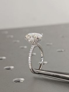 a close up of a diamond ring on a piece of metal