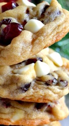 three cookies stacked on top of each other with cranberries and white chocolate chips