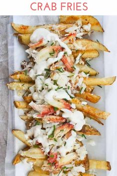 french fries covered in white sauce and garnished with fresh herbs