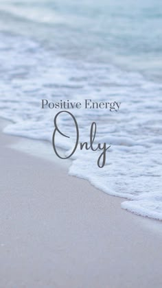 the words positive energy only are written in front of an image of water and sand