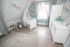 a baby's room with a crib, dresser and bed in the corner