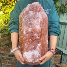 a person holding a large rock in their hands