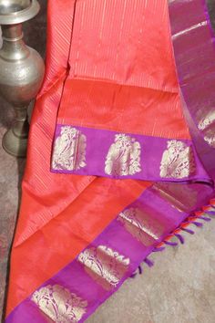 Orange 80/20 Kanchivaram saree with purple border, stitched blouse Purple Cotton Silk Blouse With Zari Weaving, Purple Cotton Silk Traditional Wear With Self Design, Purple Cotton Silk Dupatta With Pallu Detail, Purple Cotton Silk Dupatta With Pallu, Purple Cotton Silk Pallu Dupatta, Purple Zari Weaving Traditional Wear In Cotton Silk, Purple Cotton Silk Traditional Wear With Zari Weaving, Purple Cotton Silk Saree For Puja, Festive Purple Handloom Blouse Piece