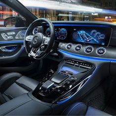 the interior of a mercedes c - class coupe with blue lights and black leather seats