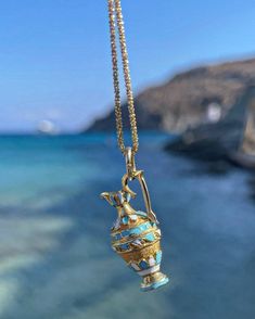 Please be advised that this order is MADE TO ORDER. Please allow 6-8 weeks for production. Channel your inner ancient Greek Goddess with these handcrafted pendants.  Handcrafted of solid 14 karat solid gold, this pendant features a Grecian vase with baked enamel blue & white finishes and filigree work.  Attached to a 20 inch curb link cabin.  Weighs 7 grams.  Measures just over one inch long. The Grecian Vase or Amphora is typically a one or two handled vessel used to transport olive oil and win Ceremonial 14k Stamped Pendant Jewelry, Handmade 14k Gold Amulet Necklace, Ceremonial Artisan Yellow Gold Jewelry, Traditional 14k Gold Collectible Jewelry, Luxury Handmade 14k Gold Necklaces, Artisan Yellow Gold Collectible Jewelry, Handmade Antique 14k Gold Necklace, Unique Yellow Gold Necklace For Ceremonial Use, Traditional 14k Stamped Pendant Jewelry