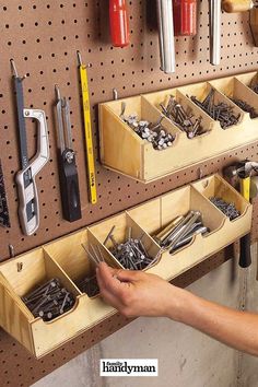 a man is working in his garage with tools on the pegboard and hanging from the wall