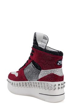 Bold cone studs highlight the platform sole of this shimmery high-top sneaker that brings together sporty and glam influences. 2" platform Lace-up style Cushioned footbed Leather upper and lining/rubber sole Imported Trendy High-top Wedge Sneakers With Studded Outsoles, Red Platform High-top Sneakers, Trendy High-top Platform Sneakers With Studded Outsoles, Red High-top Platform Sneakers, Red High-top Custom Sneakers With Studded Outsoles, Sporty High-top Sneakers With Rhinestones, High-top Synthetic Sneakers With Rhinestones, Sporty High-top Sneakers With Spikes And Round Toe, High-top Rhinestone Sneakers For Streetwear