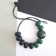 With every order you get a gift. Welcome!🤗 Modern necklace. Necklace that you can wear with jeans or as an elegant evening necklace... Very comfortable to wear. Color: black and green. Length  cord 55 cm. Dimension beads approx 25mm . Big gren/ black bead (medalion) dim 35mm. Made when ordered. Polymer clay is a relatively new material. For jewelry made of polymer clay, do not act like it's metal or wood jewelry. Clay is durable and elastic but, of course, can break. It's advisable to keep the Handmade Green Polymer Clay Necklace, Elegant Handmade Polymer Clay Necklaces, Everyday Handmade Green Necklace, Evening Necklace, Jewelry Clay, Necklace Polymer Clay, Modern Necklace, Polymer Clay Necklace, Clay Necklace