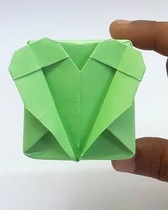 someone is holding an origami piece in their hand