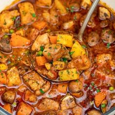 a pot filled with meat, carrots and potatoes