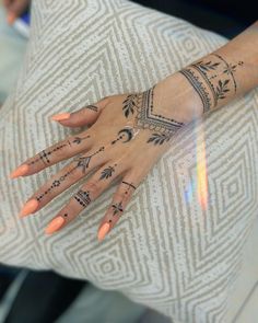 a woman's hand with tattoos on it