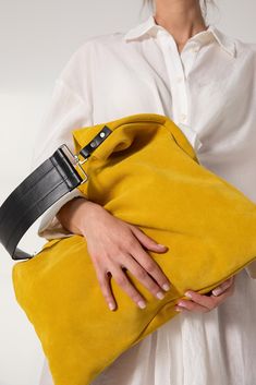 Akathi bag in yellow. A beautiful large hobo bag which is ideal for every day use. Not just a shoulder bag, a statetment tote which can easily be used as a shopper bag, even as a beach bag. It's loose minimalistic look makes it modern and unique. Handmade in our studio from lux italian suede yellow leather and a premium black cow leather for the strap. Big rectangular metal loops in silver are used to connect the strap with the bag and a silver swivel clasp is added in the interior for handling Large Capacity Yellow Pouch Shoulder Bag, Chic Large Capacity Yellow Bag, Chic Yellow Bags With Large Capacity, Luxury Large Capacity Yellow Shoulder Bag, Yellow Pouch Bag With Detachable Handle, Yellow Pouch Bag For Errands, Chic Large Capacity Yellow Satchel, Chic Yellow Satchel With Large Capacity, Chic Yellow Pouch Satchel