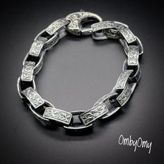 925 Sterling silver rectangular links form the geometric chain of this Celtic modern men's Bracelet. Each rounded, double-sided link of the handcrafted interlocking chain is Greek patterns based on armor designs dating back 3500 years.  The sterling silver rectangles add a sleek vibe of modern day affluence. Size: 9 inches long and 6mm thick. 71.8 grams Material: 925 Sterling Silver. Silver Bracelet With Polished Rectangular Links, Sterling Silver Bracelet With Rectangular Links And Polished Finish, Sterling Silver Bracelet With Polished Rectangular Links, Sterling Silver Chain Bracelet With Rectangular Links, Luxury Sterling Silver Oval Link Box Chain Bracelet, Luxury Sterling Silver Bracelet With Box Chain, Metal Link Bracelets With Engraving, Luxury Silver Oval Link Chain Bracelet, Engraved Metal Link Bracelets