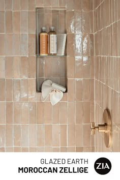 a tiled bathroom with a shelf holding personal care items