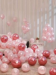 pink and white balloons are scattered on the floor