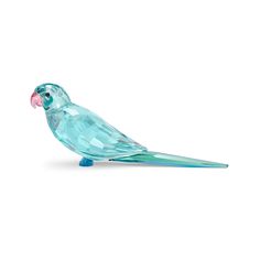 a glass bird sitting on top of a table