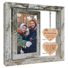 an old frame with two hearts hanging from it