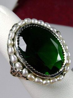 Emerald Ring, Seed Pearls surround and accent the simulated oval stone with sterling silver Victorian filigree Exquisite Oval Green Emerald Ring, Exquisite Green Oval Emerald Ring, Exquisite Green Emerald Sterling Silver Ring, Green Oval Jeweled Jewelry, Formal Green Emerald Cut Crystal Ring, Formal Green Emerald-cut Crystal Ring, Exquisite Green Round Jewelry, Exquisite Green Emerald Jewelry, Elegant May Birthstone Crystal Ring