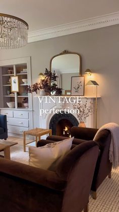 a living room filled with furniture and a fire place under a chandelier in front of a fireplace