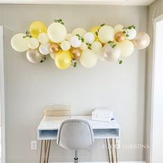 balloons are hanging on the wall above a desk