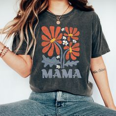 "The most adorable boho Mama shirt there is!  Perfect for everyday!  Everyone's favorite Tee! Comfort Colors makes the perfect tee for both traditional and oversized styling! Soft-washed fabric brings extra coziness to your wardrobe while the relaxed fit makes it the perfect daily choice. .: 100% ring-spun cotton .: Medium fabric (6.1 oz/yd² (206.8 g/m .: Relaxed fit **PLEASE NOTE** - Rolled Sleeves in photos are for styling purposes only - Props use in photos are not included or available for p Multicolor Bohemian Relaxed Fit T-shirt, Bohemian Multicolor Relaxed Fit T-shirt, Bohemian Style Multicolor Relaxed Fit T-shirt, Bohemian Soft-washed Relaxed Fit Top, Bohemian Soft-washed Relaxed Top, Casual Cotton Tops With Boho Print, Bohemian Cotton Tops With Boho Print, Bohemian Cotton Top With Boho Print, Bohemian Soft-washed Tops With Crew Neck