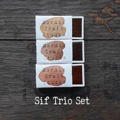 three pieces of chocolate sitting on top of a wooden table with the words, world troi set