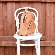 A beautiful rustic camel leather backpack with an outside pocket, double pocket interior and zipper interior with an adjustable strap that takes it from a basic backpack to an over the shoulder bag too. About 9" x 12" Shipping on custom items takes 8-10 business days. Brown Leather Backpack With Zipper Pocket, Over The Shoulder Bag, Over The Shoulder Bags, Custom Items, Leather Backpack, Camel, Adjustable Straps, Backpacks, Shoulder Bag