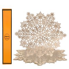 an orange box and white paper cut snowflakes