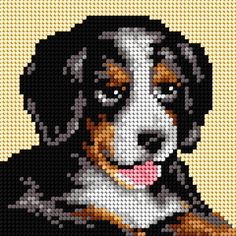 a cross stitch bead pattern of a black, white and brown dog with his tongue hanging out