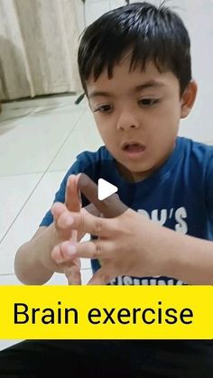 a young boy is playing with an electronic device