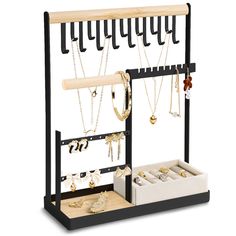 a jewelry rack with several necklaces and earrings on display in front of a white background